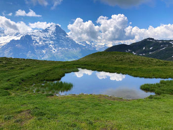 Scenic view of lake and mountains against sky