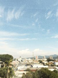 Buildings against cloudy sky