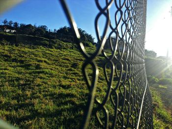 Close-up of chainlink fence on field