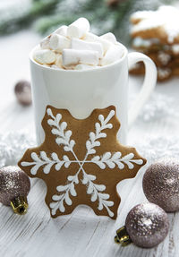 Christmas cocoa, gingerbread cookies and decorations. white wooden background.