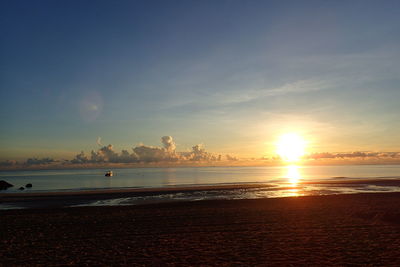 Scenic view of beach against sky during sunset