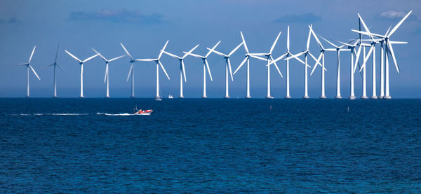 Sailboats in sea against sky