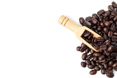 High angle view of coffee beans against white background