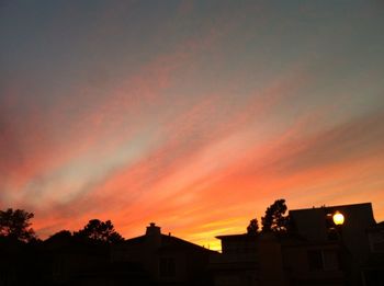 Low angle view of built structure against sky at sunset