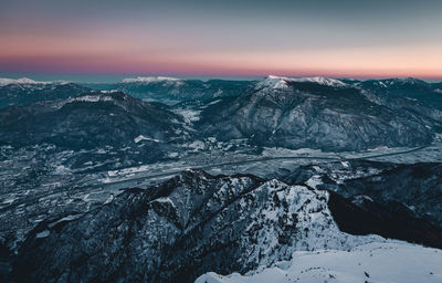 Scenic view of snowcapped mountains against sky during sunset