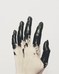 Close-up of hand against white background