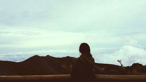 Scenic view of mountains against cloudy sky