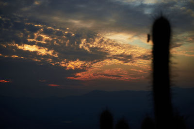 Scenic view of silhouette mountains against sky during sunset
