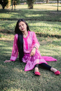 Portrait of a woman sitting on a field