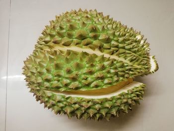 Close-up of berries on table against white background