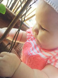 Close-up of baby lying on bed