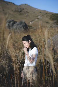 Young woman standing on field