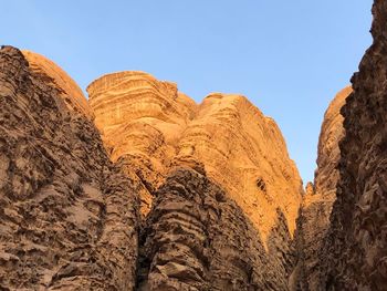 Low angle view of rock formations in desert against sky