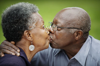 Close-up of senior couple kissing in backyard