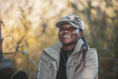 Happy african woman with a cap outside in the beautiful swedish autumn