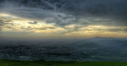 Scenic view of landscape against cloudy sky