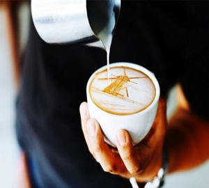 Close-up of hand holding coffee cup