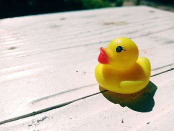 Close-up of yellow toy floating on table