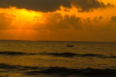 Scenic view of sea against orange sky