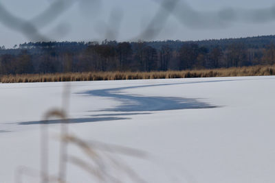 Scenic view of snow covered land against sky