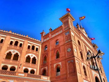 Low angle view of historical building against blue sky