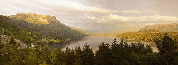 Panoramic view of lake amidst trees against cloudy sky