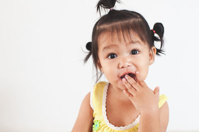 Close-up of cute baby girl eating at home