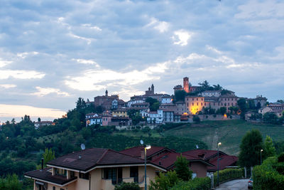 Residential buildings against cloudy sky