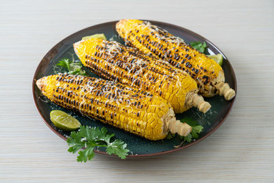 High angle view of corns in plate on table