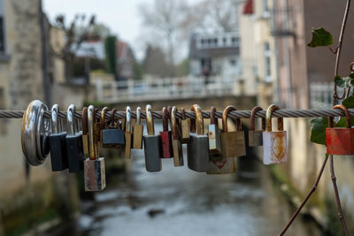 Close-up of padlocks hanging on railing