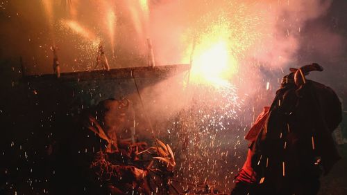 People with fire crackers at night