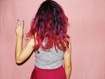 Woman with hands hair against white background