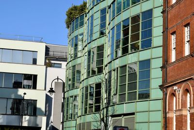 Low angle view of buildings against clear blue sky