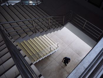 High angle view of person walking on staircase in building