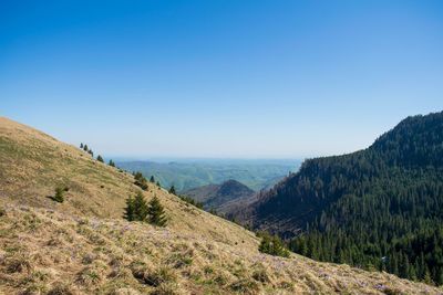 Scenic view of mountains against clear blue sky