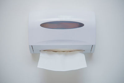 Close-up of tissue box on white wall