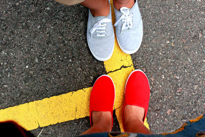 Low section of people standing on road