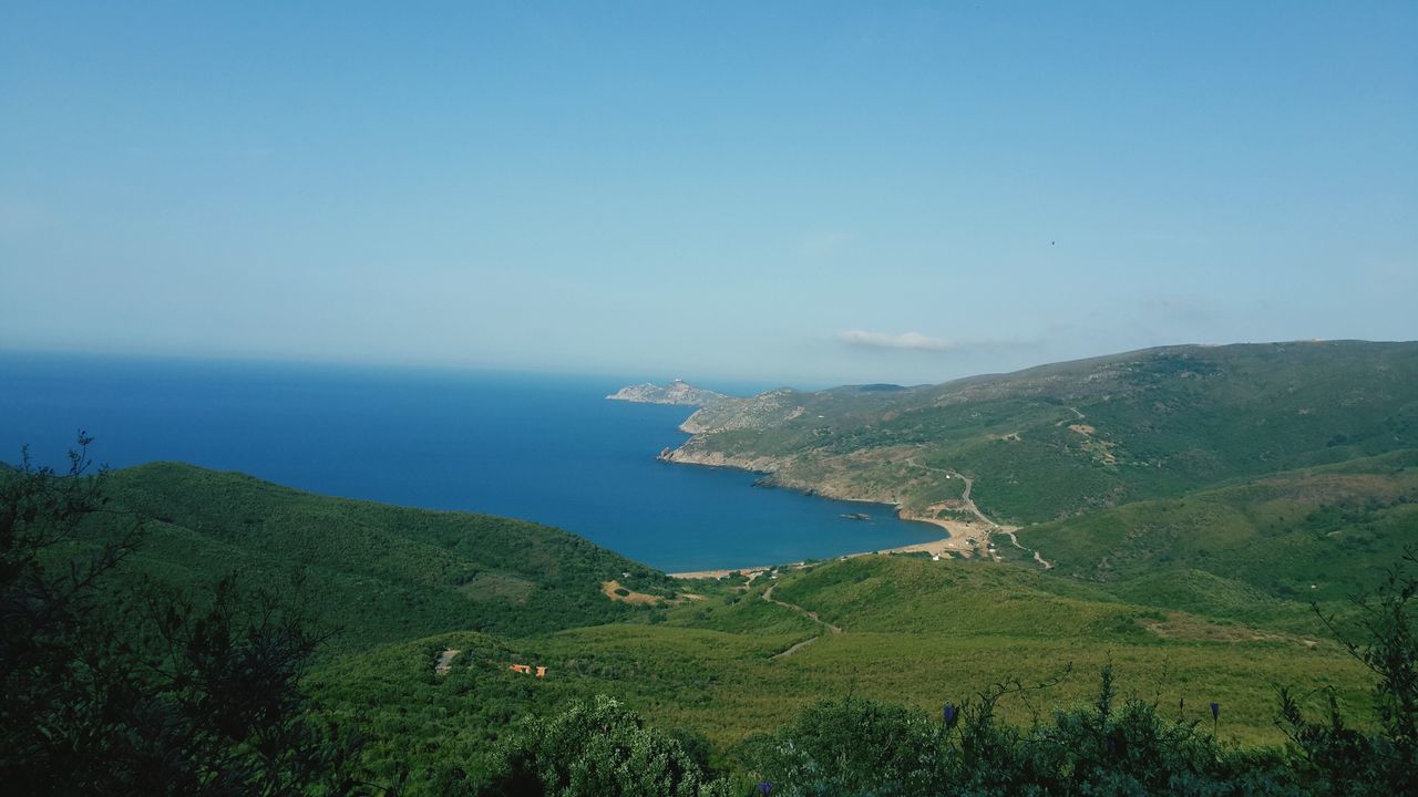 sea, tranquil scene, horizon over water, scenics, tranquility, water, beauty in nature, high angle view, blue, nature, landscape, copy space, clear sky, mountain, coastline, idyllic, sky, green color, grass, hill