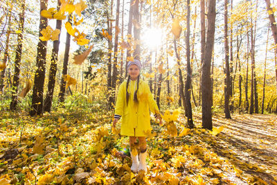 Man standing by trees in forest during autumn