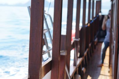 Close-up of metal railing against sea