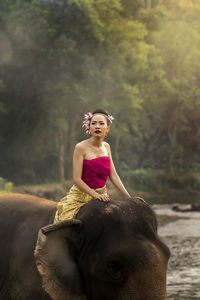 Full length of a woman sitting on land