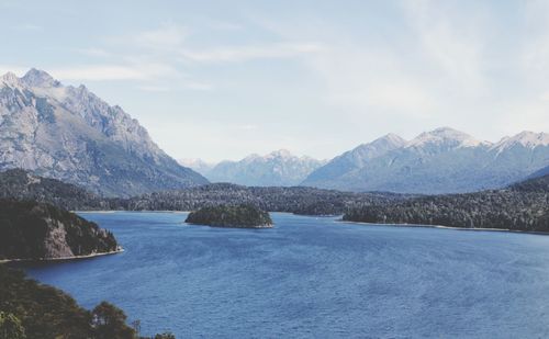 Scenic view of lake and mountains against sky