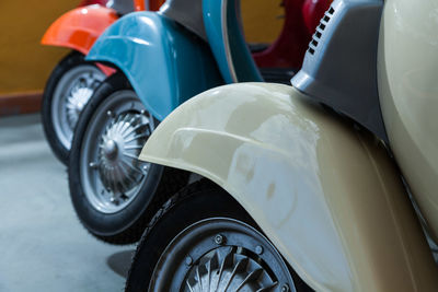 Close-up of scooters parked at shop