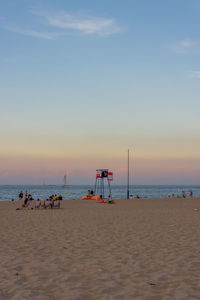 Scenic view of beach against sky during sunset
