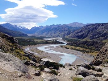 Scenic view of river and mountains against sky