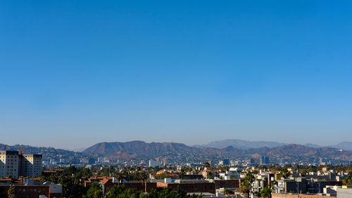 Townscape against clear blue sky