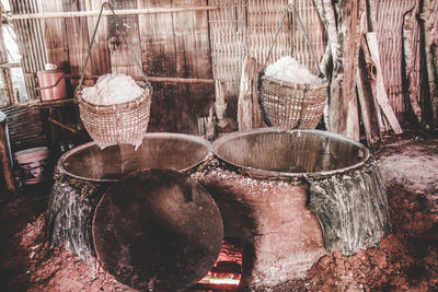 Close-up of wicker basket hanging on wooden floor