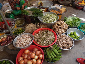 Midsection of vendor selling vegetables in market