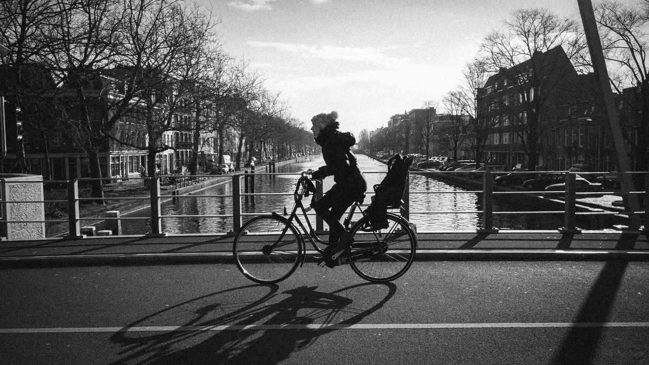 SILHOUETTE MAN RIDING BICYCLE ON ROAD