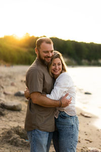 Portrait of young couple standing on shore